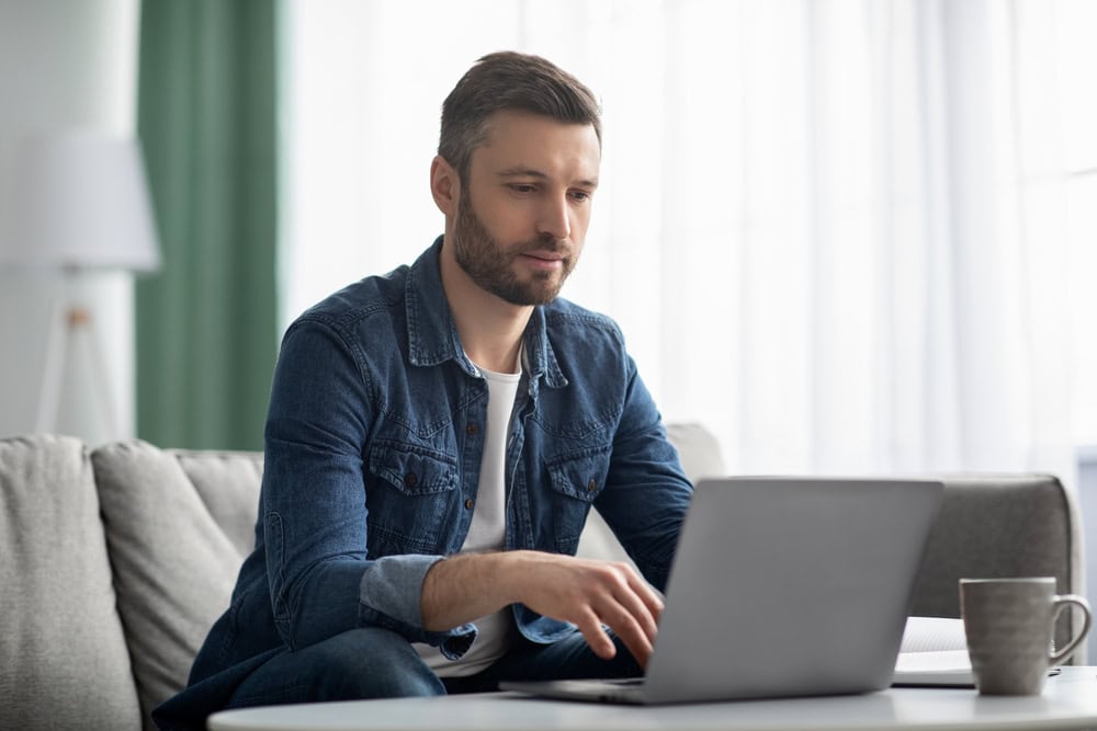 Man using laptop at home