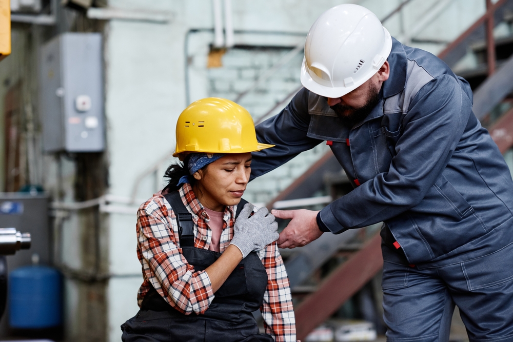 foreman,in,hardhat,and,workwear,standing,by,female,engineer,with