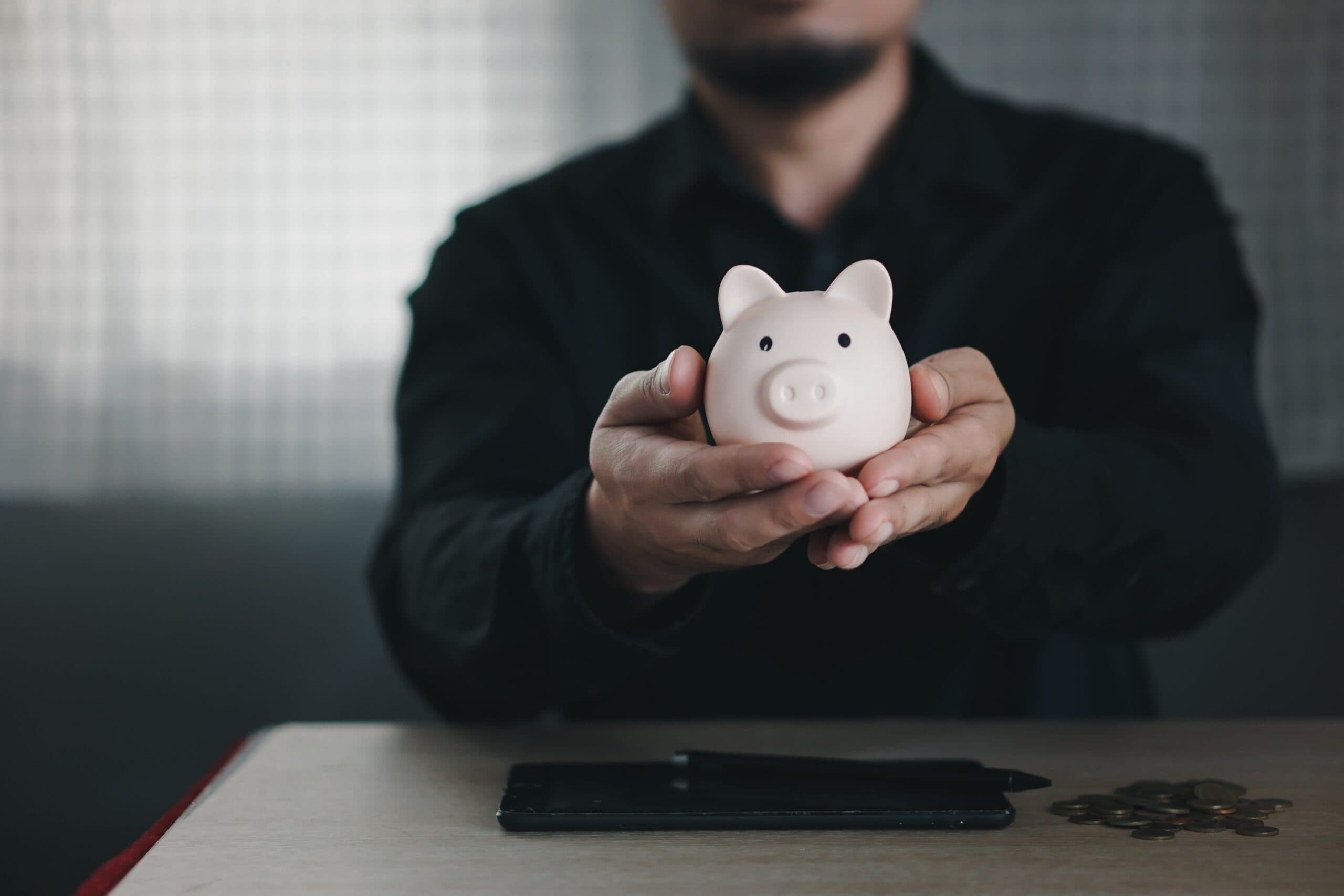 male businessman holding a piggy bank to signify your superannuation account