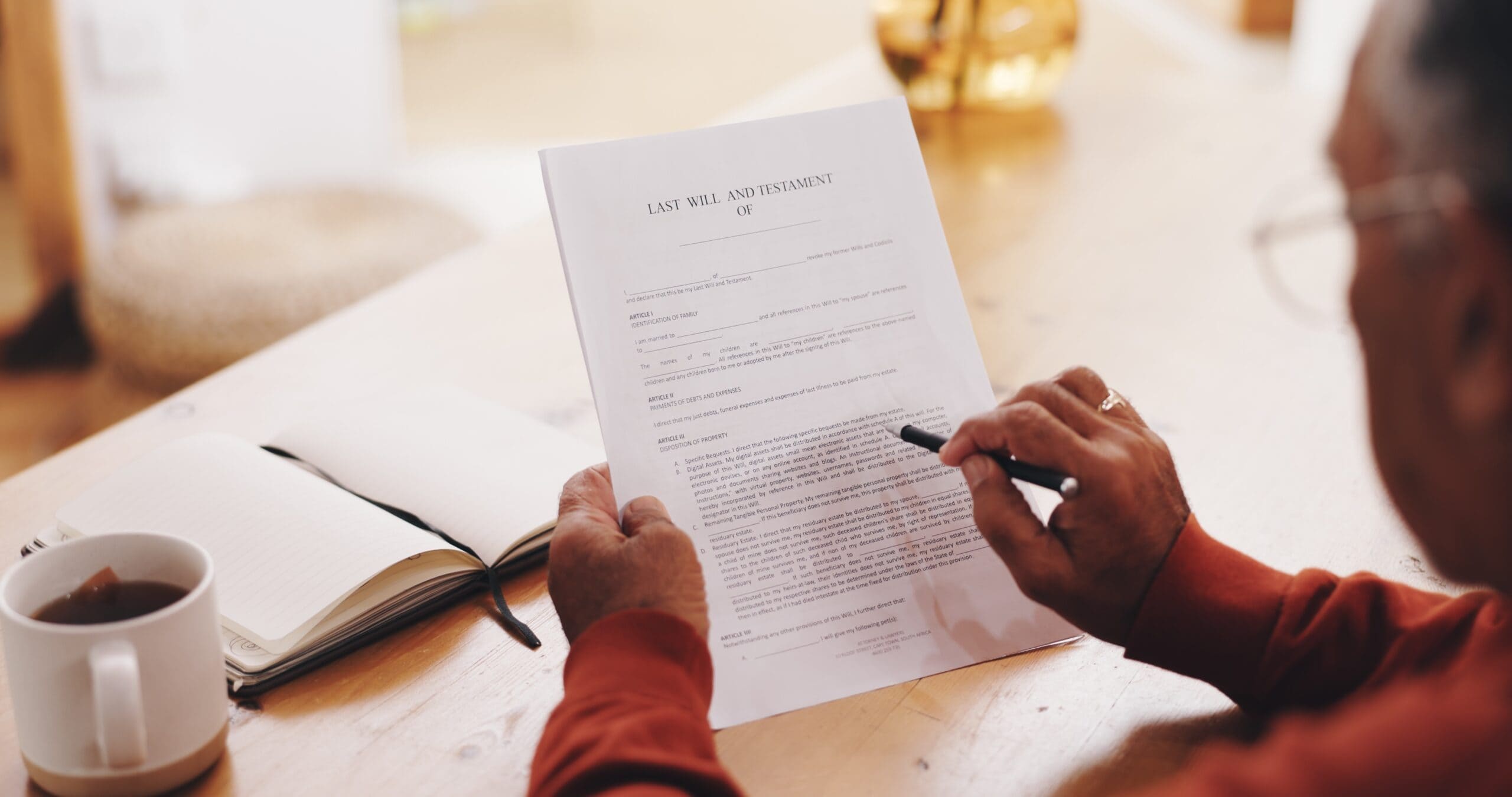 man reading a will with a cup of coffee